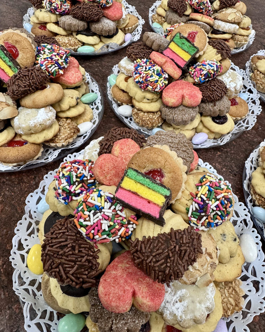 Assorted decorated cookies on clear trays