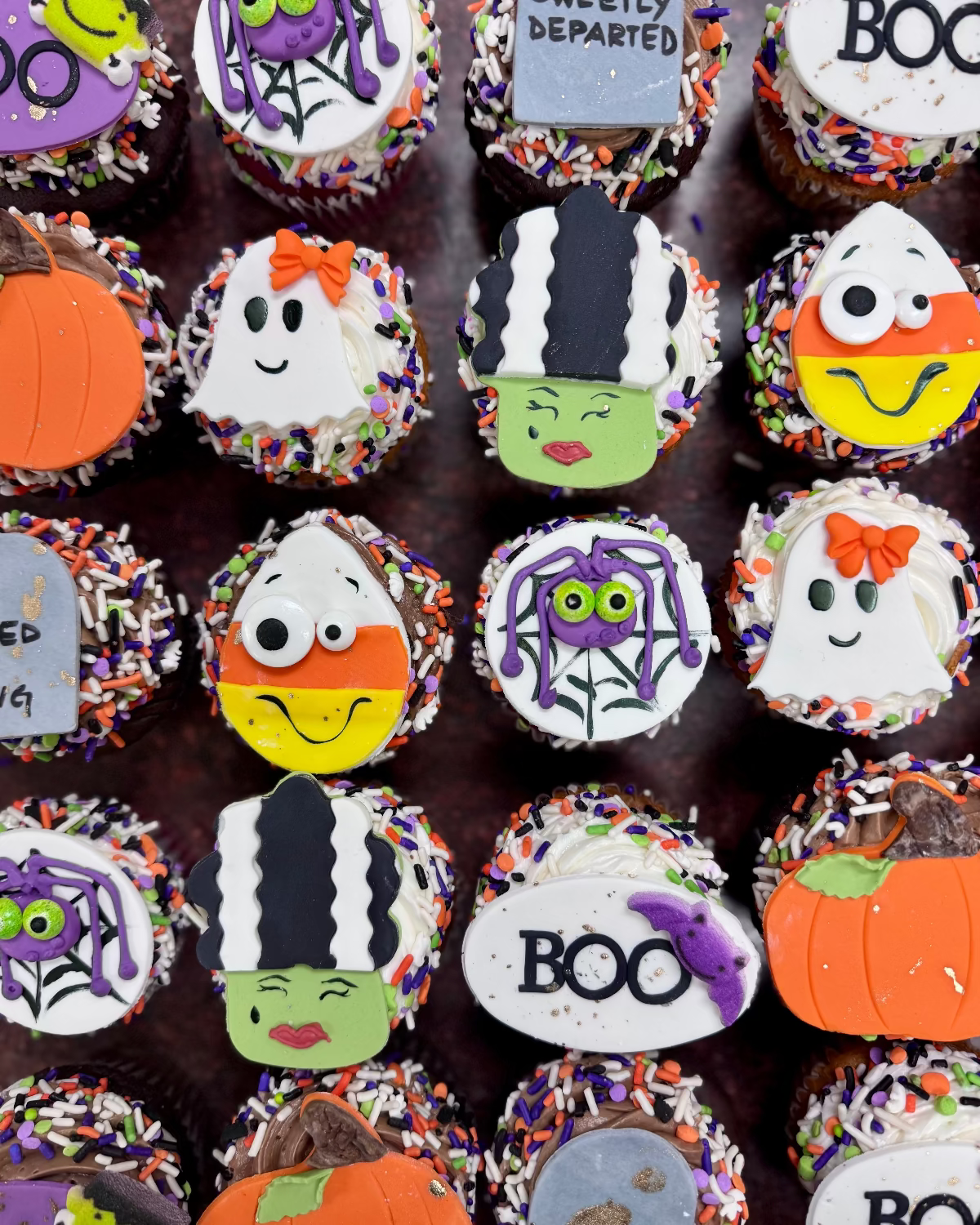 Halloween-themed cupcakes with various decorations 