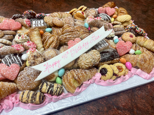Assorted cookies and pastries on a platter with a 'Happy 40th Birthday' banner.