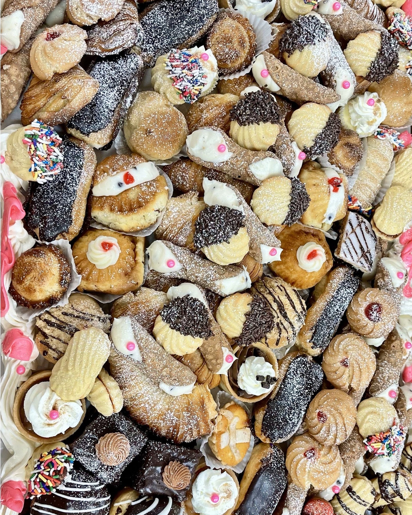 Assorted assortment of cookies with various toppings and glazes.