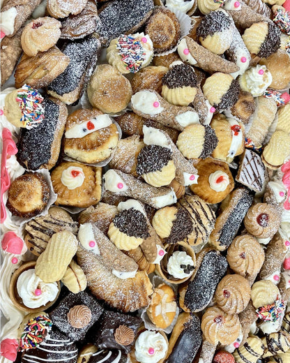 Assorted assortment of cookies with various toppings and glazes.