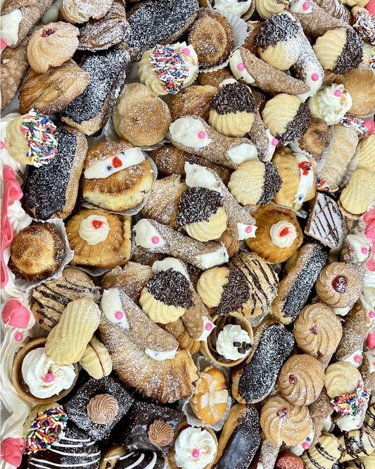Assorted assortment of cookies with various toppings and glazes.
