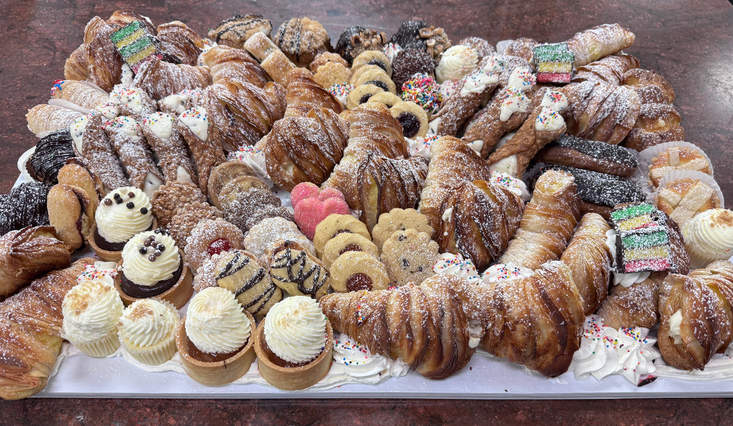 Assorted pastries including lobster tails, cookies, and tarts on a tray.