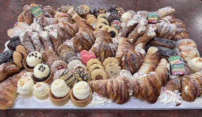 Assorted pastries including lobster tails, cookies, and tarts on a tray.