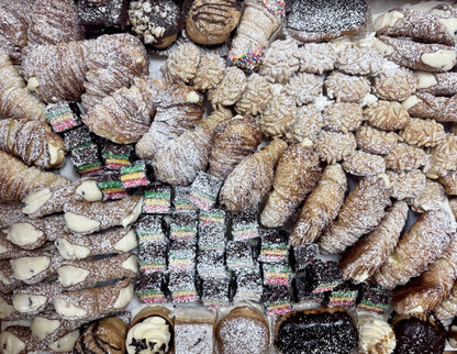 Assorted pastries including lobster tails and cookies on a white plate