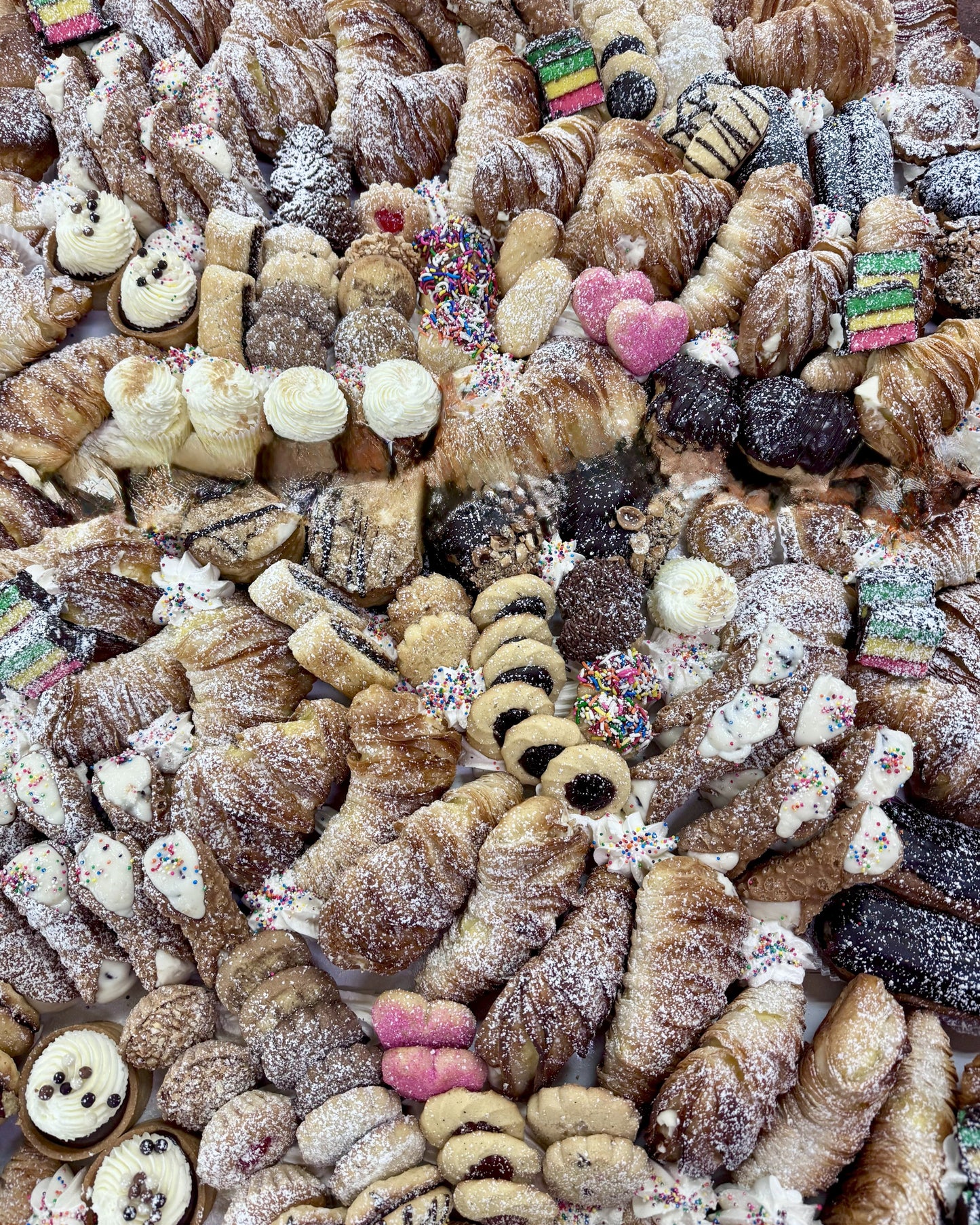 Assorted pastries with various toppings and decorations.